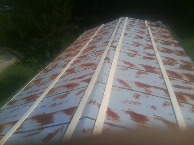 Rusted metal roof panels with new wood purlins before replacement — Storm Damage Roof Repair in Cutler by Roofing Brothers